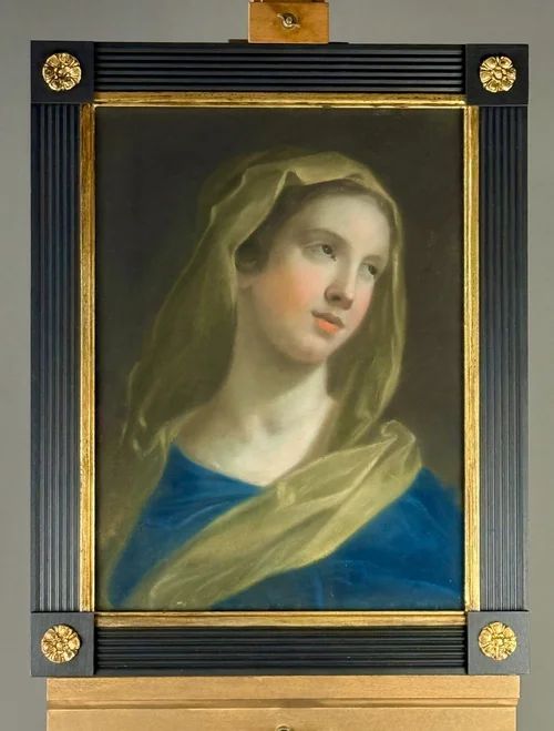 fig 1. An 18th-century pastel portrait depicting the Virgin Mary wearing a blue gown and yellow drapery, set inside a black reeded frame with gilt corner rosettes.