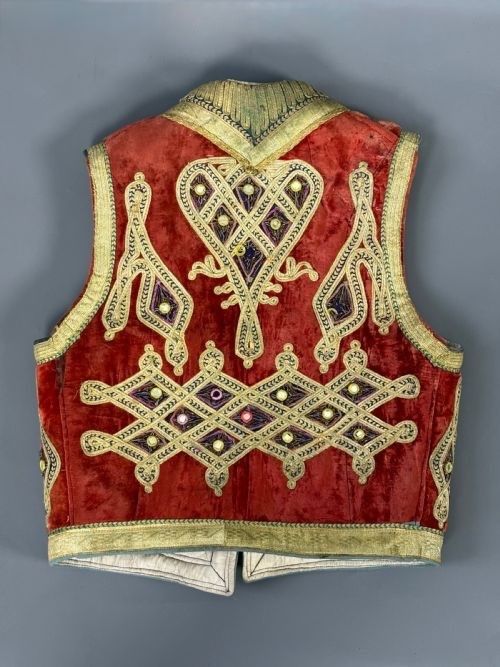 fig 1. A 19th-century Ottoman red velvet waistcoat featuring gold metallic couched embroidery and a quilted cream silk lining.
