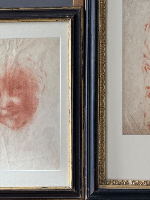 fig 2. A pair of framed antique red chalk drawings on paper depicting a childs head and a draped standing figure, set in ebonised frames with gilt inner rims.
