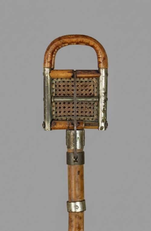 fig 2. An Edwardian bamboo shooting stick featuring folding handles with woven cane panels and metal fittings.