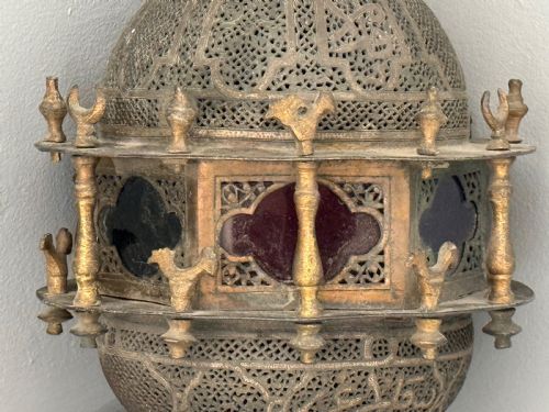 fig 1. A 19th-century Moorish style hanging lantern made of intricate pierced brass with small balusters and inset cobalt blue glass panels.