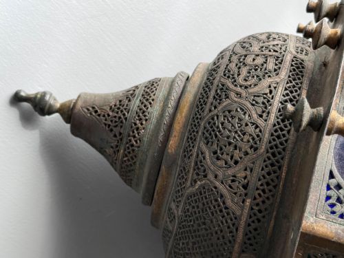 fig 3. A 19th-century Moorish style hanging lantern made of intricate pierced brass with small balusters and inset cobalt blue glass panels.