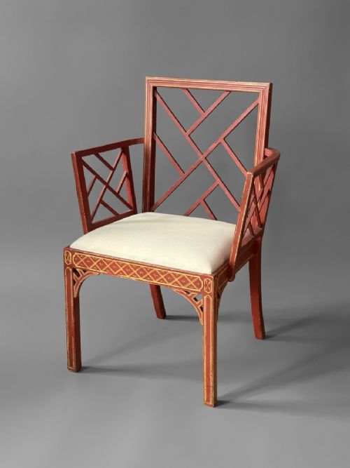 fig 3. A pair of red painted and gilded armchairs with geometric lattice backs and sides and light cream upholstered seats.
