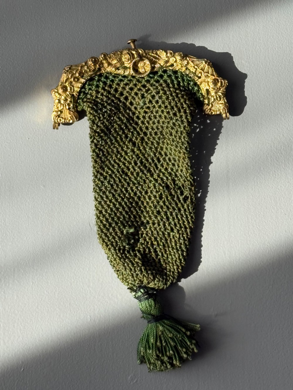 A collection of seven 1920s evening bags featuring micro-beaded floral patterns, silver mesh, and decorative metal frames arranged on a flat surface. View XIII