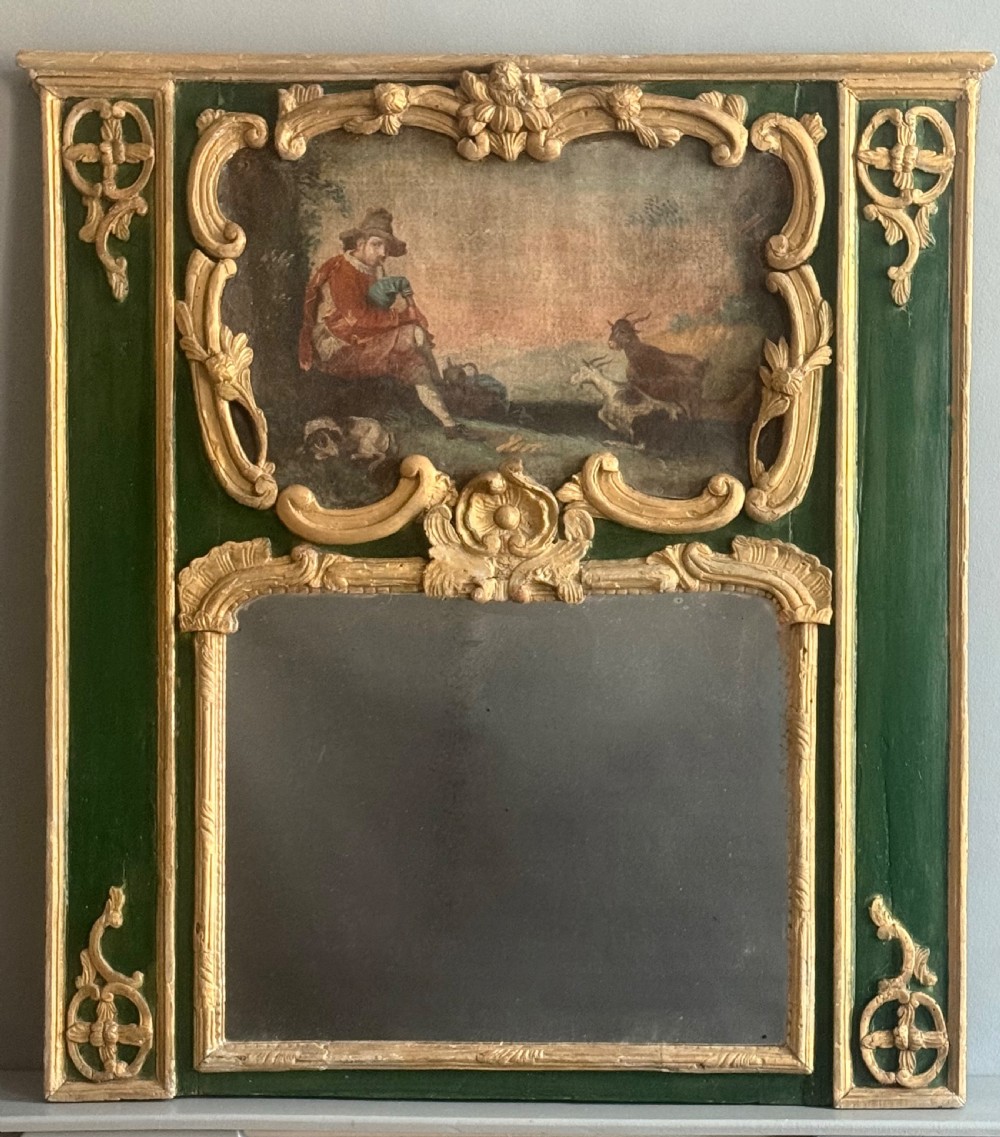 An eighteenth-century style French Rococo trumeau mirror featuring a painted green timber frame with carved gilded scrollwork surrounding an upper landscape painting and a lower rectangular mirror plate. View VI