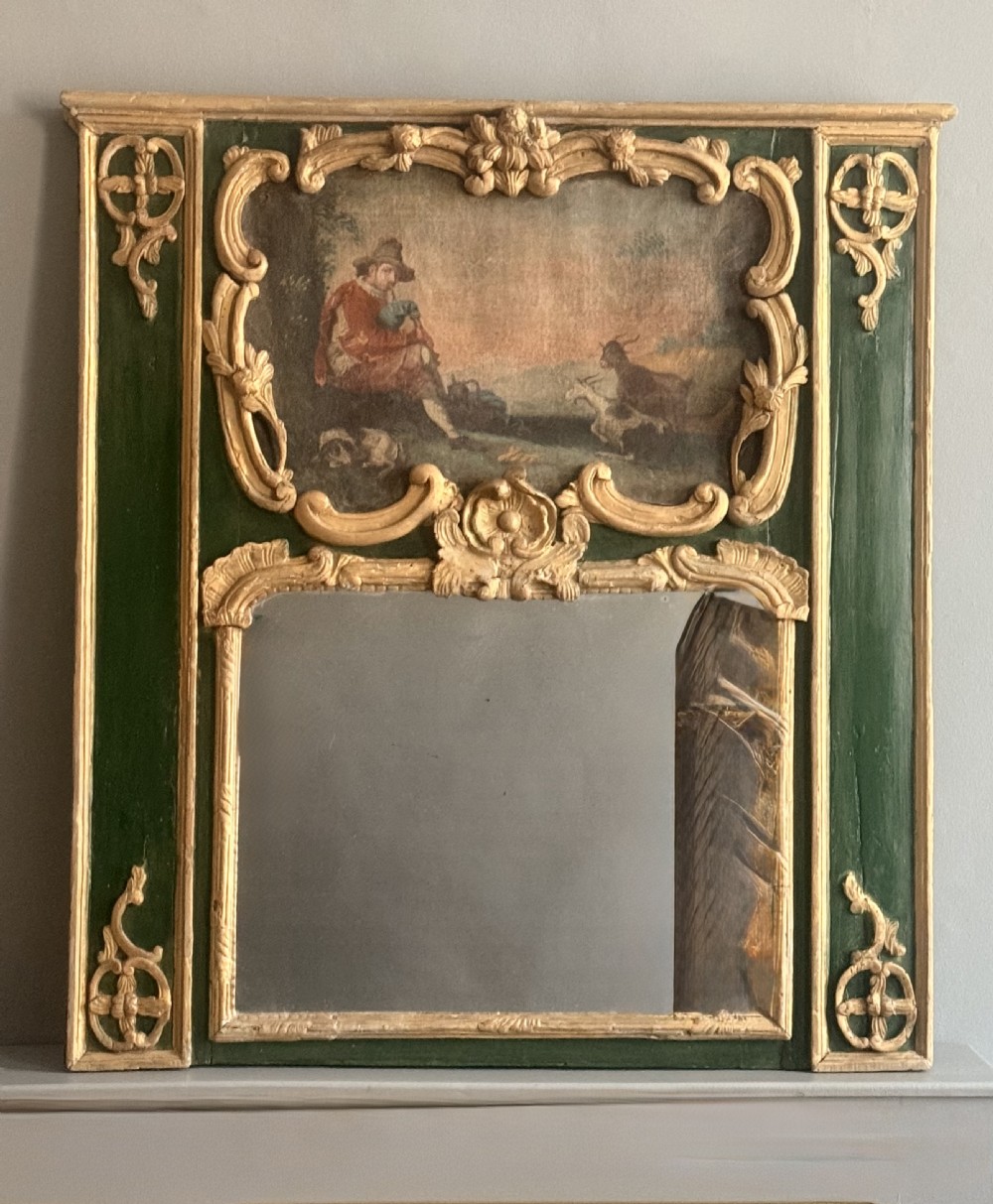 An eighteenth-century style French Rococo trumeau mirror featuring a painted green timber frame with carved gilded scrollwork surrounding an upper landscape painting and a lower rectangular mirror plate. View VII