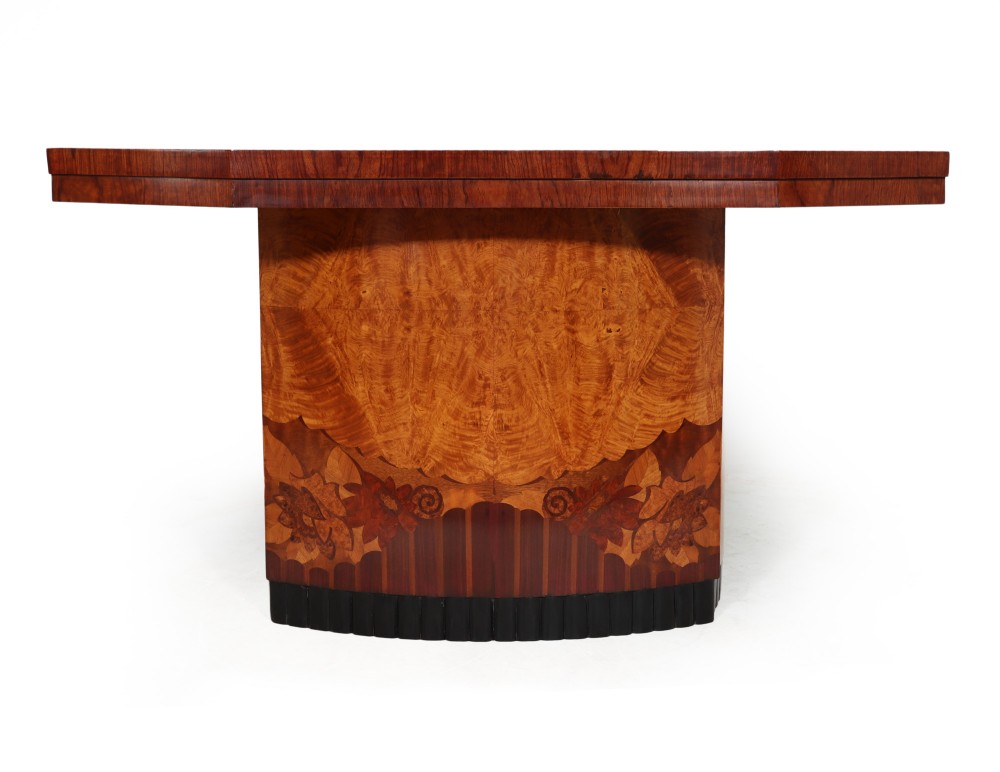 A French Art Deco console table crafted from burr walnut with floral marquetry inlay and a dark ebonised fluted base.