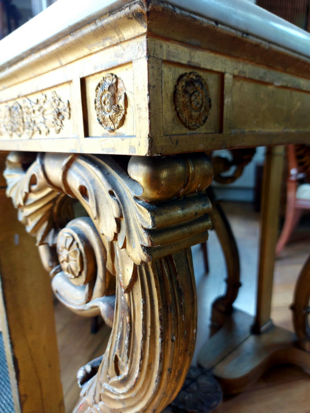 A late 18th-century Italian Neoclassical giltwood console table with a marble top, paired with a matching tall gilded mirror frame. View III
