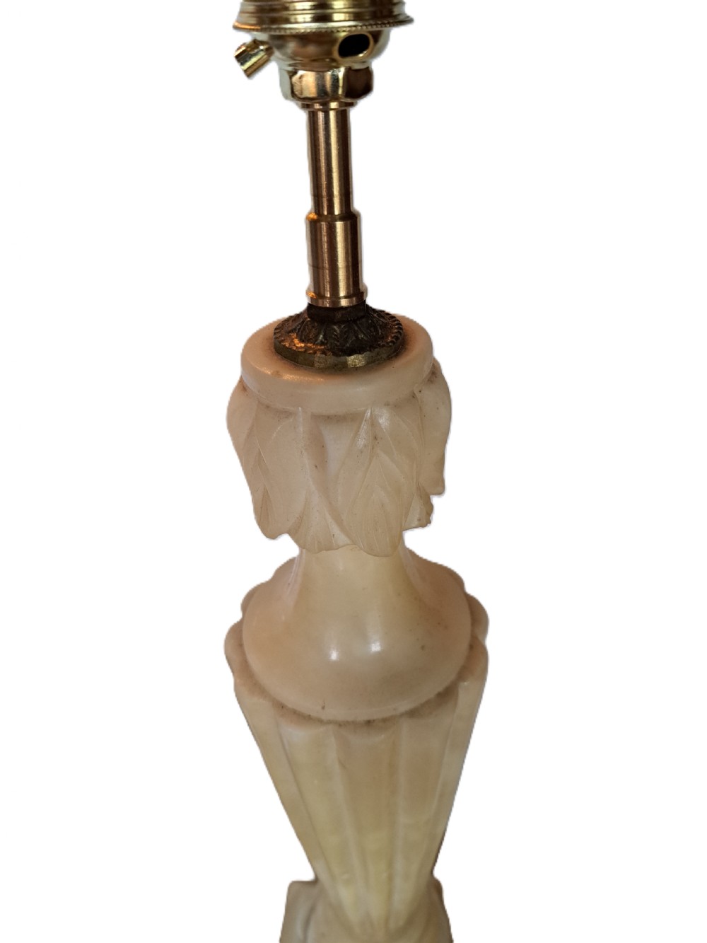 A tall carved cream alabaster table lamp base featuring a square pedestal, a fluted tapered body, carved leaf detailing, and a brass bulb socket. View II