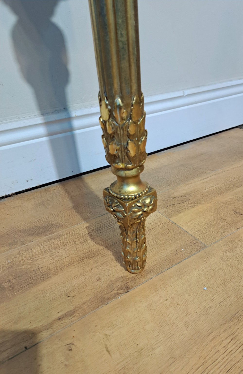 A pair of nineteenth-century French Neoclassical giltwood corner console tables with white marble tops and fluted single legs. View III