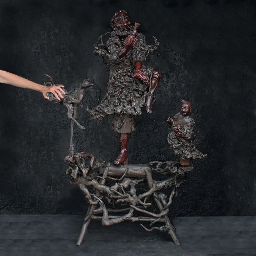 fig 1. A 19th-century Chinese carved burr root wood sculpture depicting a central figure flanked by a bird and attendant on a natural rootwood base.