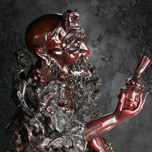 fig 2. A 19th-century Chinese carved burr root wood sculpture depicting a central figure flanked by a bird and attendant on a natural rootwood base.