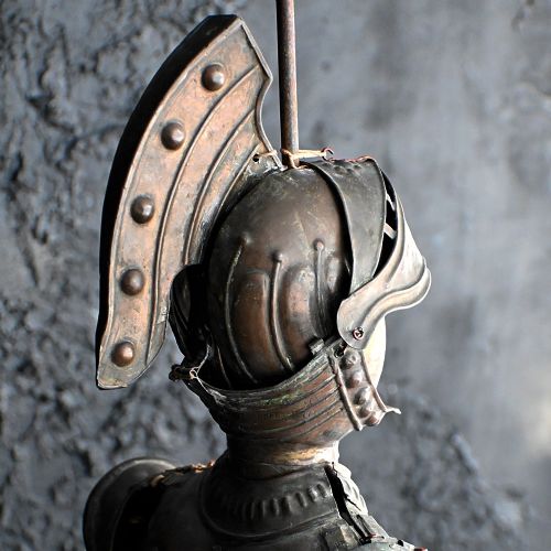 fig 2. A nineteenth-century Sicilian marionette depicting an armoured knight holding a sword and shield, crafted from carved wood and embossed metal.
