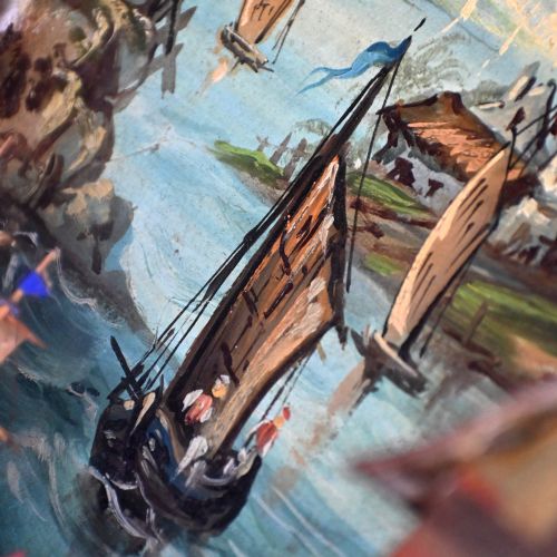 fig 3. A nineteenth-century framed picture clock shadowbox featuring a painted coastal village scene with a windmill, clock tower, and sailing vessels inside a gilt frame.