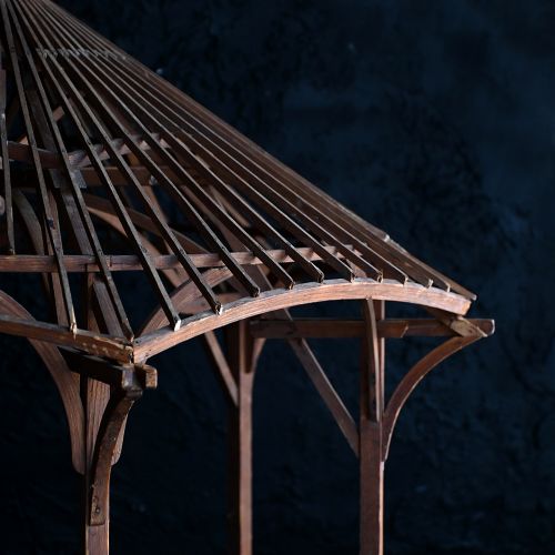 fig 2. An early twentieth-century hexagonal pine architectural model of a gazebo with exposed rafters and a central roof finial.