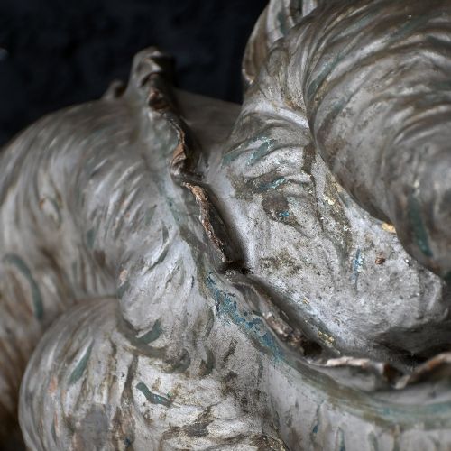 fig 2. An early twentieth-century hand-carved wooden fairground ride fragment depicting an elongated silver dragon with open jaws and detailed scale carving.
