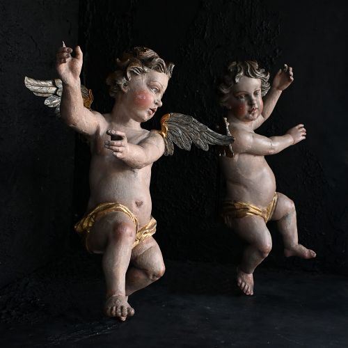 fig 1. A pair of early nineteenth-century hand-carved wooden angels featuring polychrome paint, winged backs, and draped gold leaf loincloths.