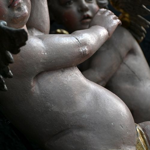 fig 3. A pair of early nineteenth-century hand-carved wooden angels featuring polychrome paint, winged backs, and draped gold leaf loincloths.
