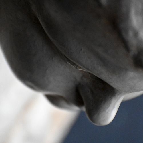 fig 2. A late 18th-century hand-carved wooden cherub figure with outstretched arms, detailed wings, and a painted grey finish.