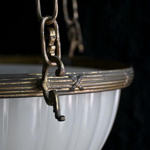 fig 2. An early 20th-century ribbed white glass bowl pendant light suspended by three brass chains.