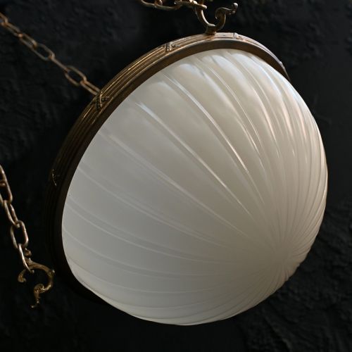 fig 3. An early 20th-century ribbed white glass bowl pendant light suspended by three brass chains.