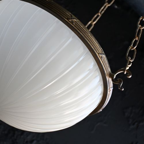 fig 4. An early 20th-century ribbed white glass bowl pendant light suspended by three brass chains.