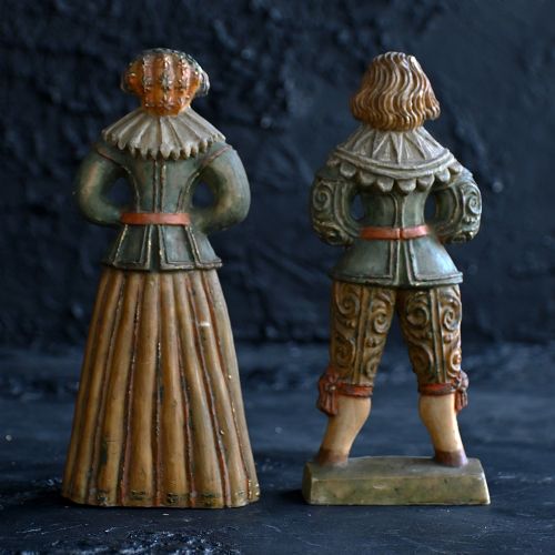 fig 1. A pair of hand-carved polychrome wax figures depicting a man and a woman in 17th-century attire with hands clasped in prayer.