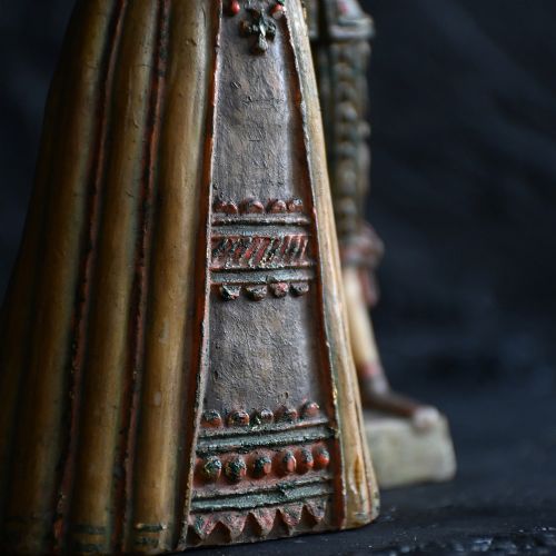 fig 3. A pair of hand-carved polychrome wax figures depicting a man and a woman in 17th-century attire with hands clasped in prayer.