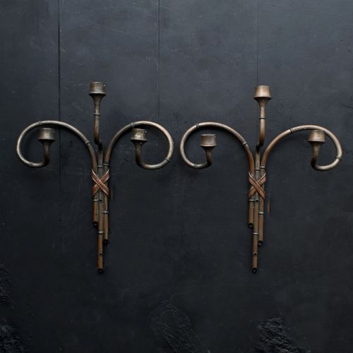 fig 2. A pair of early 20th century patinated metal wall sconces formed in the shape of bamboo stalks with three sweeping curved branches holding candle sockets.