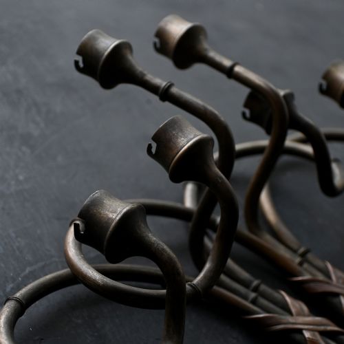 fig 4. A pair of early 20th century patinated metal wall sconces formed in the shape of bamboo stalks with three sweeping curved branches holding candle sockets.