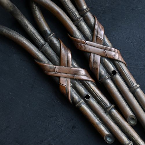 fig 5. A pair of early 20th century patinated metal wall sconces formed in the shape of bamboo stalks with three sweeping curved branches holding candle sockets.