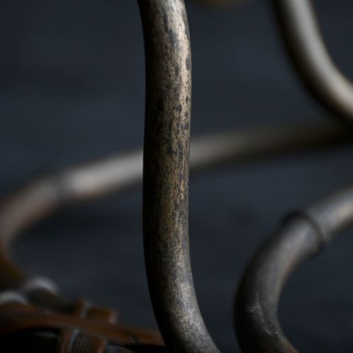 fig 7. A pair of early 20th century patinated metal wall sconces formed in the shape of bamboo stalks with three sweeping curved branches holding candle sockets.