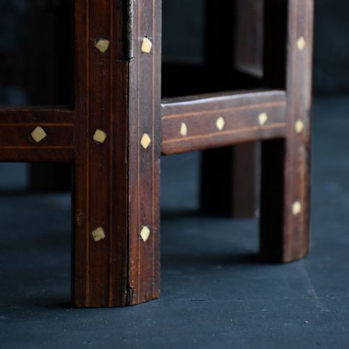 fig 5. An early 20th-century octagonal wooden occasional table featuring intricate bone inlay floral and geometric patterns across the top and arched apron base.