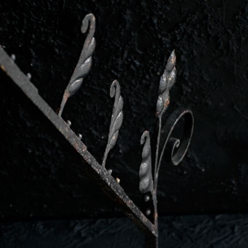fig 5. A Victorian Gothic Revival pointed archway made from dark wrought iron featuring leaf crockets and circular tracery.