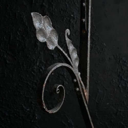 fig 6. A Victorian Gothic Revival pointed archway made from dark wrought iron featuring leaf crockets and circular tracery.