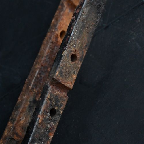 fig 7. A Victorian Gothic Revival pointed archway made from dark wrought iron featuring leaf crockets and circular tracery.