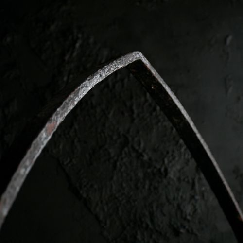fig 8. A Victorian Gothic Revival pointed archway made from dark wrought iron featuring leaf crockets and circular tracery.
