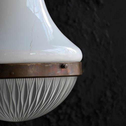 fig 3. An early 20th-century pendant light featuring a white opal glass upper shade, a patterned clear glass lower diffuser, and patinated brass fittings suspended by a chain.