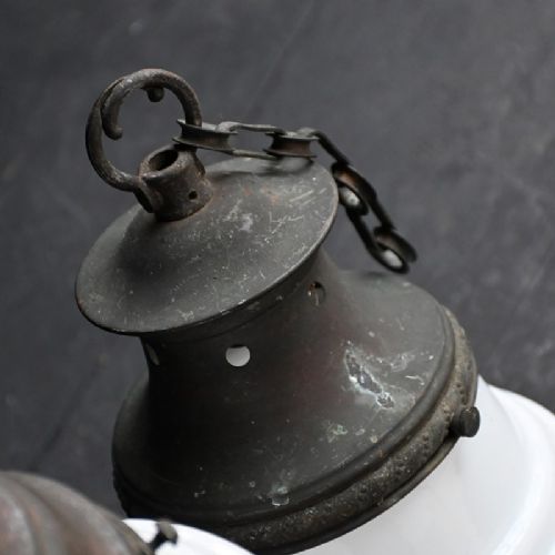 fig 4. A pair of early twentieth century opaline glass pendant lights featuring milk-white glass shades and aged brass galleries with suspension chains.