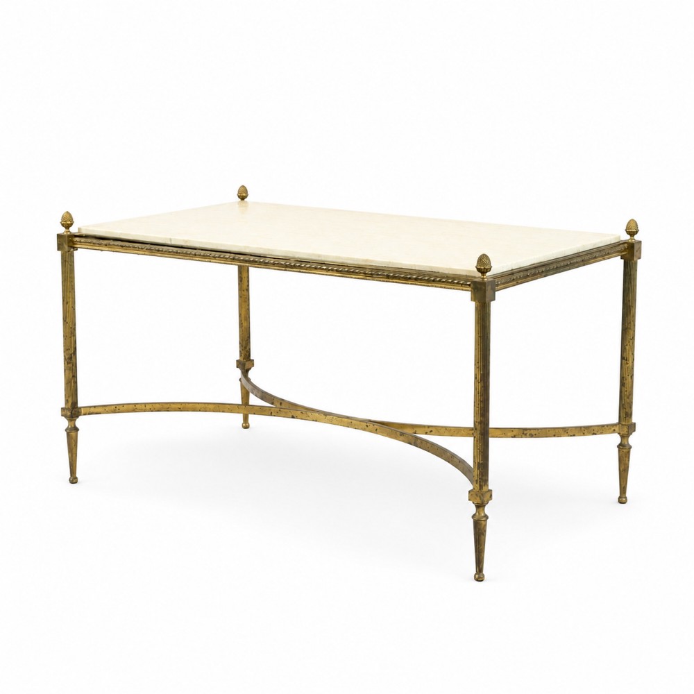 A rectangular Neoclassical style coffee table featuring a cream marble surface, a gilt brass frame with fluted legs, corner pineapple finials, and a curved stretcher.