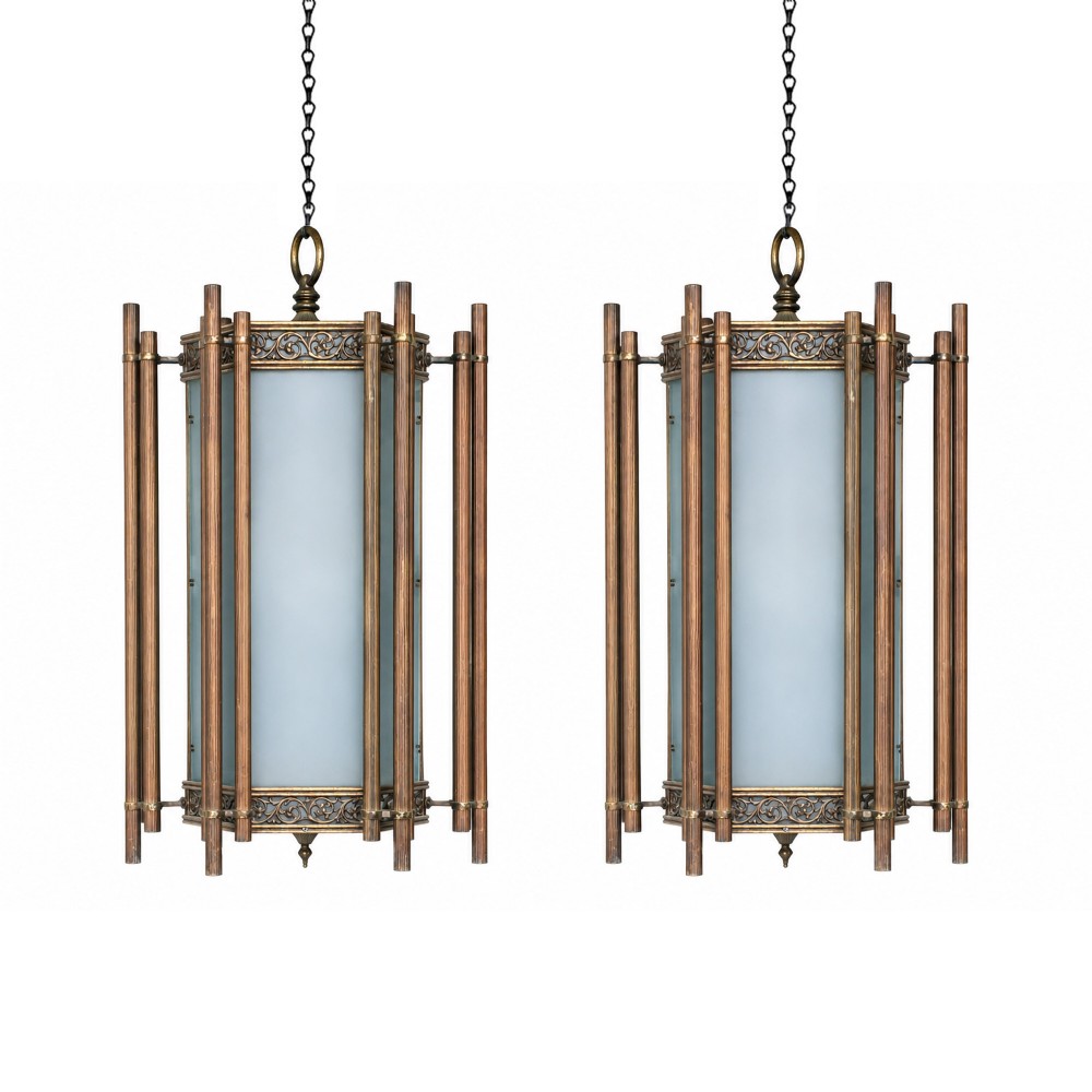 A pair of large Art Deco bronze hanging lanterns featuring frosted glass cylinders enclosed by vertical tubular rods and scrollwork filigree bands.