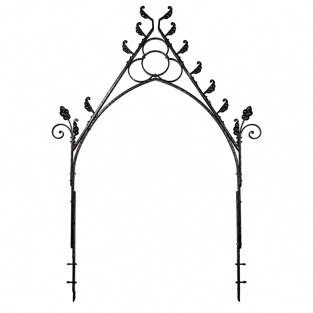 A Victorian Gothic Revival pointed archway made from dark wrought iron featuring leaf crockets and circular tracery.
