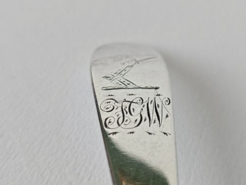 fig 1. An antique Irish Georgian silver spoon featuring an elongated oval bowl and engraved detailing along the terminal.