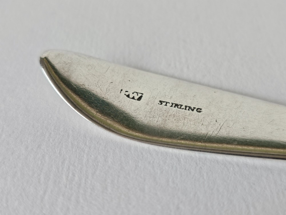 An antique Irish Georgian silver spoon featuring an elongated oval bowl and engraved detailing along the terminal. View III