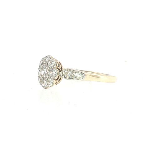 fig 2. An Edwardian 18ct yellow gold and platinum ring featuring a daisy cluster of old-cut diamonds with additional diamond accents on the shoulders.