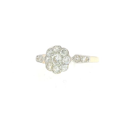fig 3. An Edwardian 18ct yellow gold and platinum ring featuring a daisy cluster of old-cut diamonds with additional diamond accents on the shoulders.