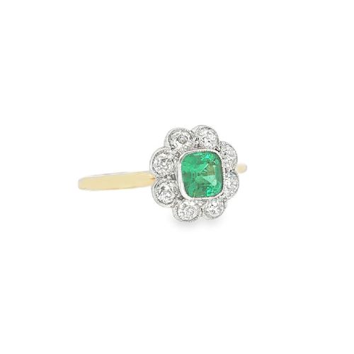 An antique 18ct yellow gold ring featuring a central square green emerald surrounded by a scalloped cluster of diamonds. View IV