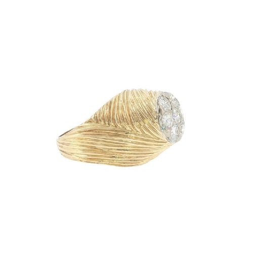 fig 1. A vintage 18ct yellow gold ring featuring a central round cluster of seven diamonds surrounded by a wide, textured gold border.