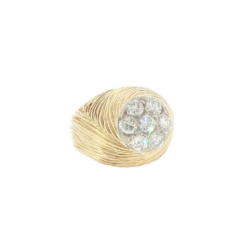 fig 2. A vintage 18ct yellow gold ring featuring a central round cluster of seven diamonds surrounded by a wide, textured gold border.