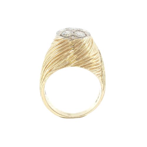 fig 3. A vintage 18ct yellow gold ring featuring a central round cluster of seven diamonds surrounded by a wide, textured gold border.